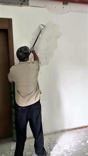 Interior wall demolition using a hammer to break plaster and remove section ASAP