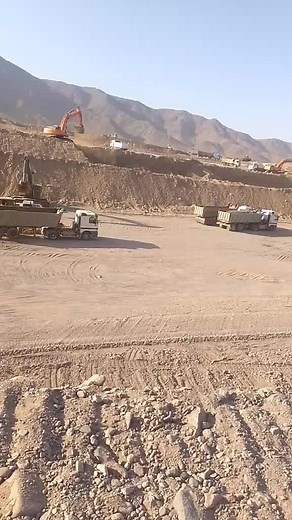 Excavator and Dump Truck Operations at Construction Site