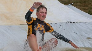 RAGBRAI riders use a slip and slide to cool down on 2022 route