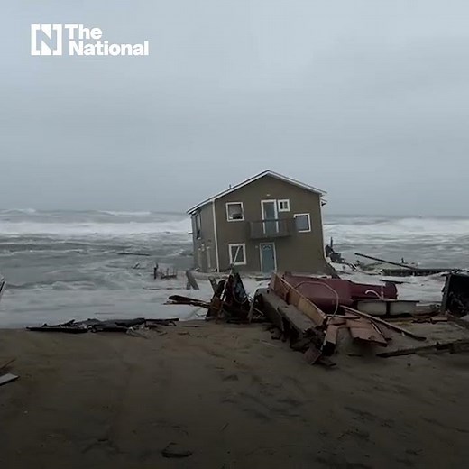 Watch as beach house collapses into waves