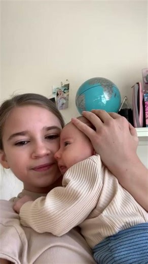 Sister singing for her newborn baby brother