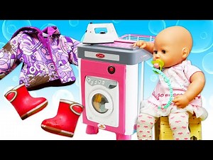 The baby doll got her clothes dirty during a walk. We help her wash clothes in a toy washing machine
