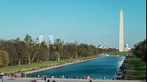 Tourists flock to the Lincoln Memorial Reflecting Pool in this time-lapse. The Washington Monument and U.S. Capitol Dome are seen in the distance.