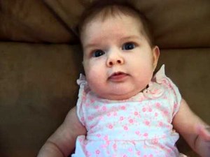 Cute 3 month old baby girl smiling and blowing bubbles - Londyn