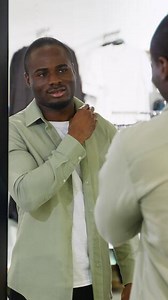 Customer trying on clothes in dressing room mirror