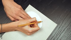 Step 4. Video tutorial DIY Easter egg made of paper for the Easter holiday. Women's hands women's hands with a pencil and ruler, make the second egg a little bigger.