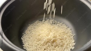 Putting rice and water in a rice cooker steamer