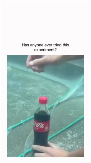 2026 on Instagram: "The X post shares a 19-second video of a hand opening a sealed Coca-Cola bottle underwater in a pool, where bubbles rise from the cap instead of the soda erupting, surprising viewers with its calm fizz. Scientifically, external water pressure equals the bottle's internal CO2 pressure, delaying gas escape per Henry's law, which states gas solubility increases with pressure; similar demos date back to at least 2022 on platforms like YouTube. With 984,000 views and 259 mostly In