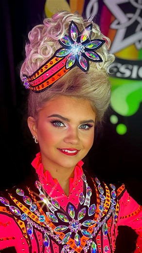 Rising Star Designs on Instagram: "Evie Rose McPeake @royaltaradanceacademy1 Evie Rose lights up the stage in this bold neon Rising Star design. A striking fusion of hot pink and vibrant orange creates instant impact, while sharp black detailing adds depth and definition under the lights. The crystal burst across the bodice draws the eye to centre stage, flowing downwards in a powerful, elongated silhouette. Every line is designed to enhance movement, every panel crafted for maximum stage presen