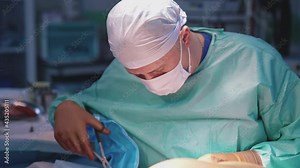 Medical specialist doing operation with surgical tools. Professional surgeon using medical scissors during plastic surgery in the operating room.