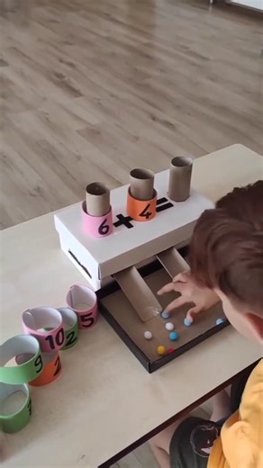 🌈DoodleTots on Instagram: "🎲✨ Hands-on Math Fun for Ages 4–6! ✨🎲 Say goodbye to boring worksheets and hello to interactive learning! 📚 Today’s activity helps little learners (ages 4–6) understand addition using a fun and engaging DIY math game made from simple materials toilet paper rolls, pom-poms, and a whole lot of creativity! 🌈🧠 👦👧 The challenge: Solve the equation 6 + 4 = ? 👉 Drop 6 pom-poms in one tube and 4 in the other. 🔢 Count all the pom-poms that come out and find the matchi