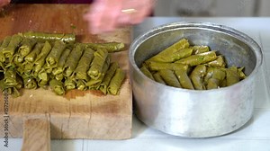 Making dolma, yaprak sarma, stuffed grape leaves, traditional turkish cuisine.