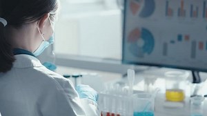 A researcher at a chemical medical laboratory puts on goggles and proceeds to experimental studies with soil and water samples to determine their ecological state and the presence of contaminants.