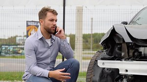 A man calling car mechanic insurance assistance after car accident