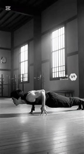 Bruce Lee is doing push-ups with two fingers.