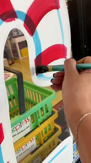 What do you do when your client wants gingerbread theme Christmas windows and it's a toy store? You turn it into Santa's workshop with a fun flare! I especially love the doors! I wanted to paint something different and I absolutely love the giant wreath on the doors! What part is your favorite? Be sure to shop local at @letoycypress for all your unique toy ideas #houstonartist #windowpainting #windowsplash #windowart #christmaswindows #christmaddecor | Decorative Painting by Laura