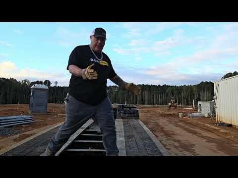 Moving heavy equipment to jobsites via lowboy tractor trailer.