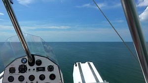 Seaplane, open cockpit flying in Florida, Gulf Coast area.