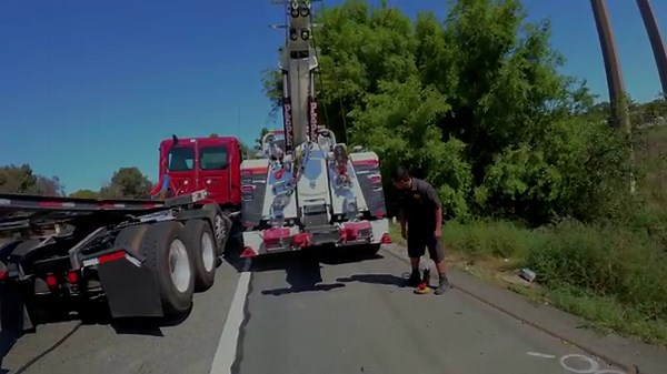 Loaded container rolls over guardrail