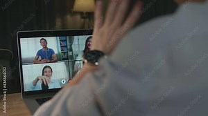 Young Asian Business Man On Video Conference Call, Using Laptop Computer Work Late Night. Remote Meeting, Work At Home, Internet Technology