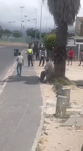 🚨 Live Incident – Manenberg 🚨 A third video has emerged showing ongoing shooting between SAPS and gangsters in Manenberg. Residents are advised to stay indoors and avoid the area until the situation is under control. 📌Source: @GarinWolf #MANENBERG #SAFETYALERT #SAPS #COMMUNITYSAFETY | Suburban Control Centre