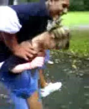 A little girl picked up and carried a big man piggyback