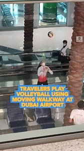 BALL CONTROL: Couple plays volleyball on moving airport walkway to pass the time as travelers wait for their flights. https://abcn.ws/3q9tOMF | ABC News