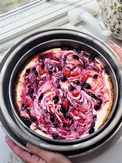 This Mixed Berry Cheesecake can be made as a no bake or baked version. It is made with an rich, velvety vanilla cheesecake base, then swirled with vibrant ribbons of a homemade strawberry and blueberry jam. The creamy cheesecake sits on top of a buttery graham cracker crust, which adds a delicious contrast in textures and flavors. Comment recipe if you’d like the full recipe sent directly to you. You can get the full recipe on my blog. https://simplebakingwithjolene.com/mixed-berry-cheesecake/ #