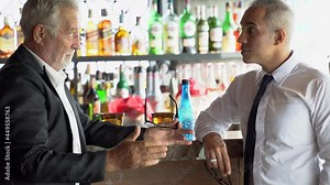 two happy senior businessman talking and drinking alcohol together after work on counter bar in restaurant . group of colleague drunk in pub