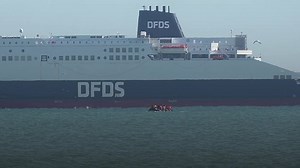 A boat carrying migrants could be seen off the coast of Gravelines in northern France on Friday morning as a family and dog walkers enjoyed the sunny weather on the beach.A French authority boat followed the dinghy closely as it travelled along the coast passing big ships such as a DFDS ferry, and a French border control helicopter flew overhead.It comes as Yvette Cooper told BBC Radio 4's Today programme it was "totally appalling" that children were being "crushed to death on these overcrowded 