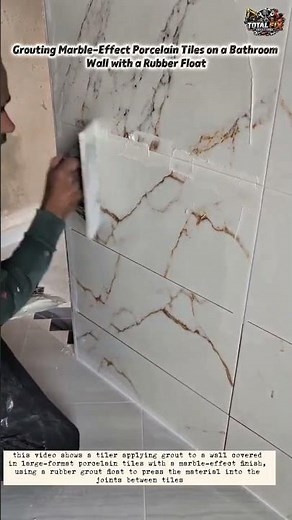 Grouting Marble-Effect Porcelain Tiles on a Bathroom Wall with a Rubber Float