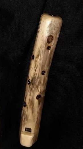 Making small wooden flute from branch