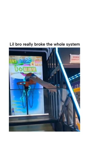 Repostspmo on Instagram: "The post showcases a 21-second video of a young man in a neon-lit Chinese arcade hurling a basketball so forcefully at a shooting game that it shatters the protective glass panel, sending shards flying while the ball scores, captioned “Lil bro really broke the whole system “ for comedic effect. Shared by @FastbreakHoops5 , a pop culture account focused on basketball highlights, the clip has exploded in popularity with 3,400+ likes and 2.5 million views since December 18