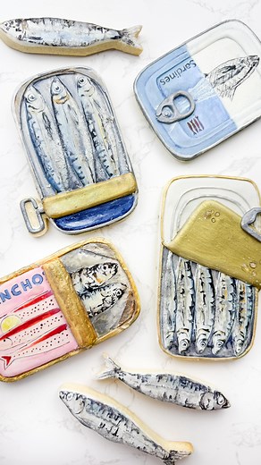 Hey Tastemakers! Tin fish or tin fish cookies?! These fintastic sugar cookies are decorated with royal icing, edible glitter, and lots of love! The perfect summer treat🐟🤍 #cookiedecorating #royalicing #handpainted #edibleart #tinfish #sardines #fish | Maya Frenklach