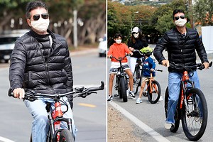 Simon Cowell takes Lauren Silverman and son Eric on bike ride while wearing protective masks amid coronavirus pandemic