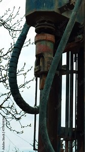 Machine element spins the forcer for drilling the ground. Machine boring the well outdoors. Vertical video.