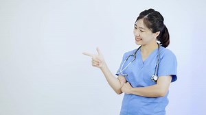 Asian female doctor pointing to a background banner