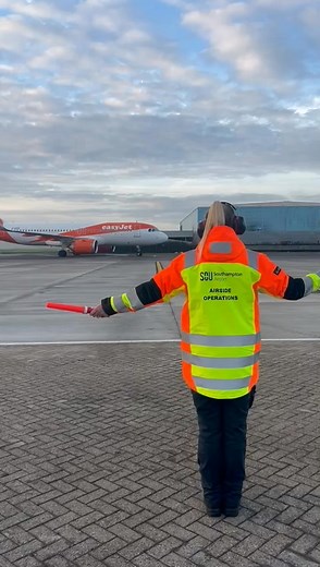 Just another day guiding aircraft at SOU ✈️ Here’s Gemma in action as part of our Airside Ops team, keeping everything moving safely and smoothly behind the scenes. (We think it looks pretty cool too!) | Southampton Airport
