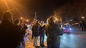 Trump supporters await his arrival outside Trump National Golf Course in Sterling