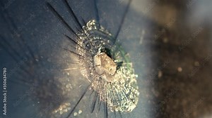 Armored glass shot through by a bullet. Close-up. Crime scene. Expert criminalist