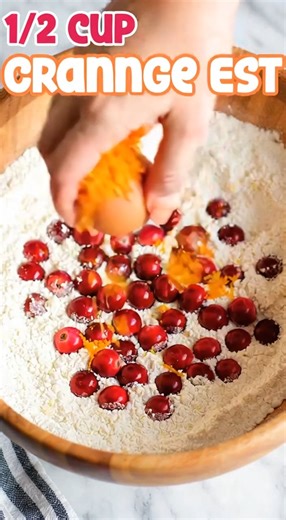Cranberry Orange Scones Recipe Ingredients: 2 cups all-purpose flour 1/4 cup granulated sugar 1 tablespoon baking powder 1/2 teaspoon salt 1/2 cup cold unsalted butter (cut into small cubes) 1 cup fresh cranberries (or dried if preferred) 1 tablespoon orange zest (about 1 orange) 1/2 cup heavy cream (plus extra for brushing) 1 large egg 1 teaspoon vanilla extract For the Glaze: 1/2 cup powdered sugar 2 teaspoons orange juice (or as needed to reach desired consistency) Instructions: Preheat the o