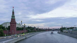 Time lapse of Moscow Kremlin and Moscow River with ships at sunset. Cars traffic on Kremlin embankment and moving clouds. Russia.