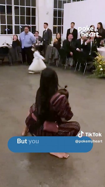 Woman Performs Leg Split at Wedding Dance While Holding Her Baby