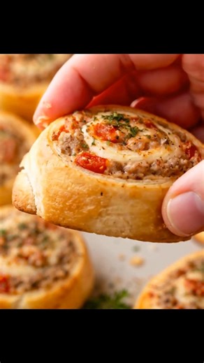 These Rotel sausage pinwheels are dangerously addictive. Just four ingredients, savory sausage, creamy cheese, and flaky crescent dough. Baked golden with a little spicy kick in every bite. Perfect party food that disappears fast. | Spicy Pepper Recipes