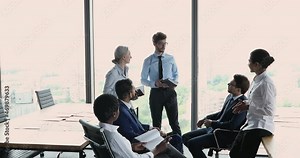 Diverse employees holding diaries discuss agenda during morning briefing in office, meeting led by male team leader, talking, consider ideas, solve current issue, work on collaborative project concept Stock Video