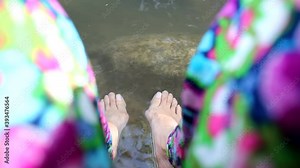Hallux valgus, woman legs barefoot with bunions in hot spring pool
