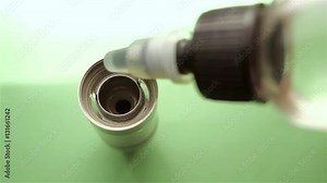 Filling of a tank for an electronic cigarette liquid close up. Rebuildable dripping atomizer (RDA). Electronic nicotine delivery systems. ENDS.