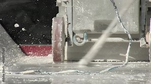 Spreading white grout on industrial flooring with industrial grouting machine