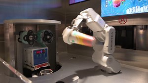 An automated robot arm prepares a beverage for a customer by combines elements of engineering, mathematics, and AI technology at a shopping mall tea store in Hong Kong | Premium Stock Video Footage