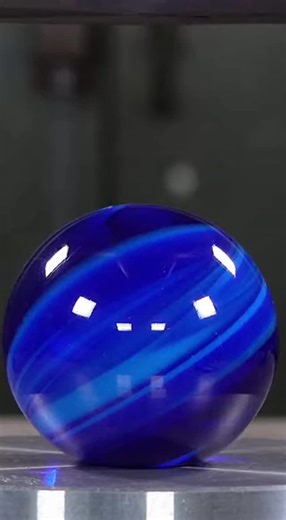 VibeASMR on Instagram: "Watch as a massive hand-blown cobalt glass orb meets its fate under extreme hydraulic pressure. The thick glass walls compress and build tension before violently exploding into hundreds of shards in a spectacular display of physics."